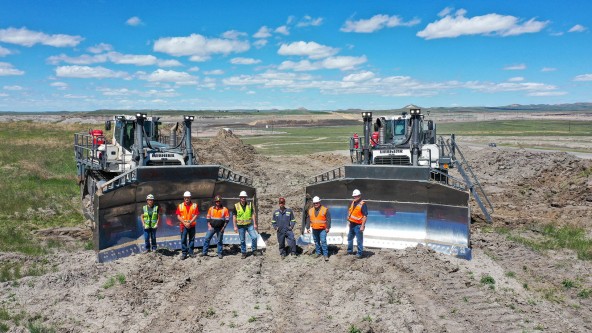 Belle Ayr Mine team standing in front of two white Liebherr PR 776 dozers