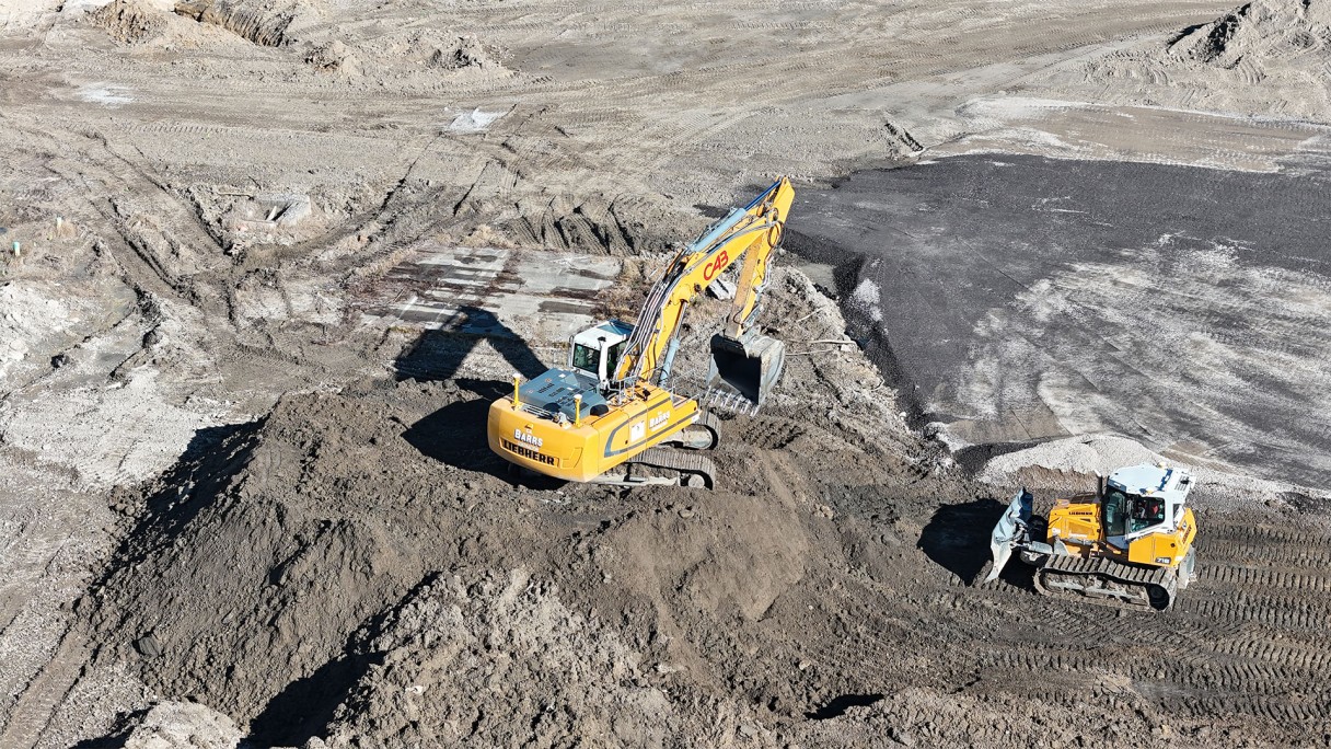 C.A. Barrs is using a yellow Liebherr R946 crawler excavator and a yellow PR 716 dozer with trimble grading to clear 8 acres for additional storage of machines at the back of Liebherr Mining Equipment Newport News, Virginia campus.